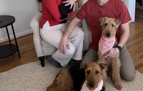 Family at home with their Airedale Terriers