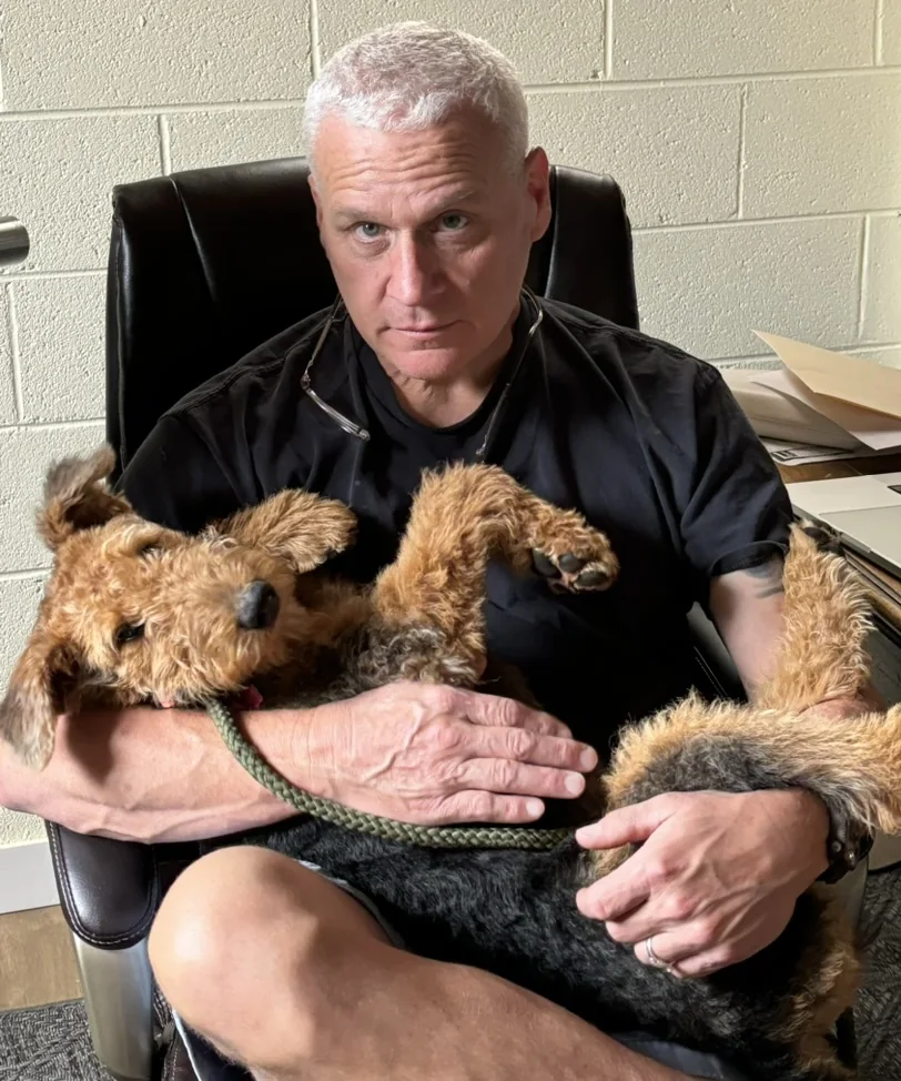 Kirk Altenburg holding Airedale Terrier puppies